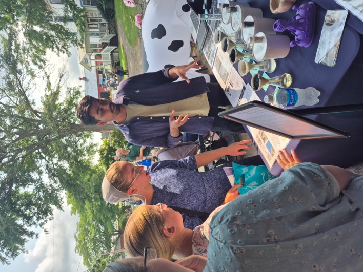 Saurab discussing biochar samples with visitors at Ag Progress Days