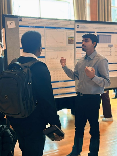 Saurab explaining his research poster to an attendee
